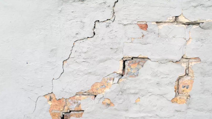 Cracks in white wall